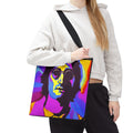 Person holding a colorful tote bag with a graphic design on a white background