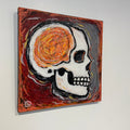 Abstract painting with a central skull-like figure on a white background