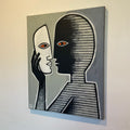 Abstract artwork of a face with a black hairdo and red eyes on a gray background