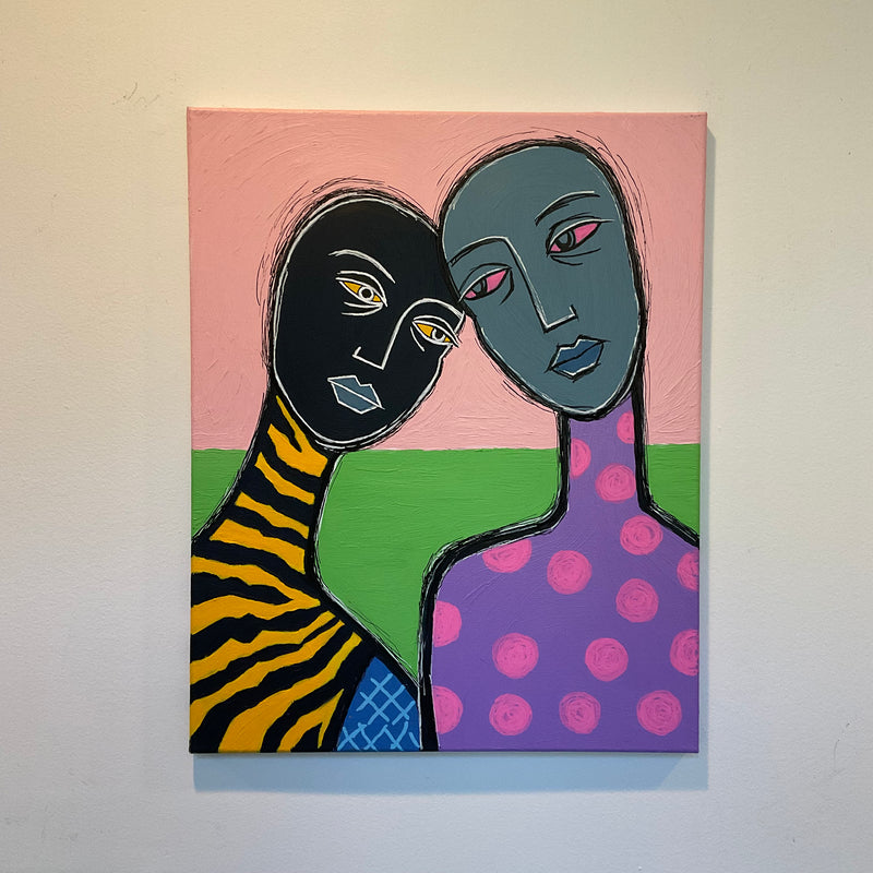 Abstract artwork of two faces embracing on a colorful background